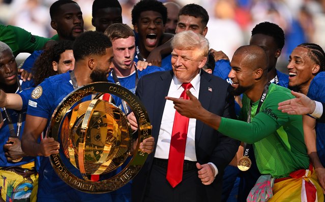 Reece James #24 of Chelsea FC holds the FIFA Club World Cup trophy after their team's victory as intereacts with U.S. President Donald Trump following the FIFA Club World Cup 2025 Final match between Chelsea FC and Paris Saint-Germain at MetLife Stadium on July 13, 2025 in East Rutherford, New Jersey. (Photo by David Ramos/Getty Images)