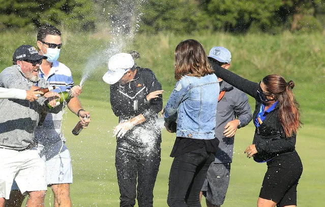 Mel Reid of England (C) is doused with champagne after winning the ShopRite LPGA Classic presented by Acer on the Bay Course at Seaview Hotel and Golf Club on October 04, 2020 in Galloway, New Jersey. (Photo by Michael Cohen/Getty Images)