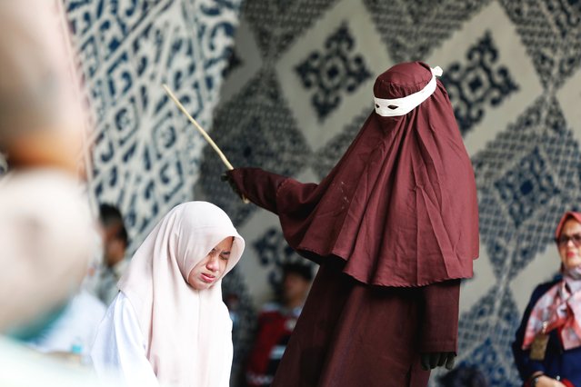 An Acehnese woman receives up to 100 time lashes of caning punishment in front of the public, for adultery and breaking Sharia law, in Banda Aceh, Indonesia, 04 June 2025. Aceh is the only province in Indonesia that enforces the Sharia law, and considers lesbian, gay, bisexual relationships, s*x outside of marriage and adultery as Sharia law violations. The controversial Islamic law was first introduced in 2001, after the country's government granted more autonomy to the region. (Photo by Hotli Simanjuntak/EPA/EFE)