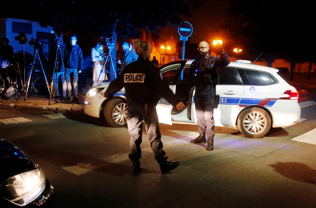 Police officers secure the area near the scene of a stabbing attack in the Paris suburb of Conflans St Honorine, France, October 16, 2020. (Photo by Charles Platiau/Reuters)