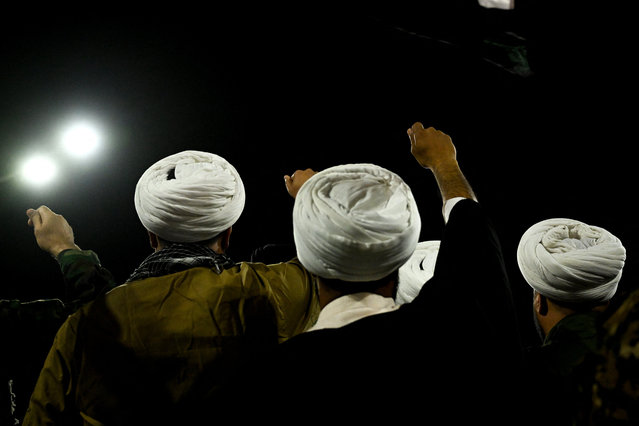 Shiite Muslim clerics shout slogans during a rally held at the Shatt al-Arab seaside promenade in the southern Iraqi city of Basra to protest Israel's strikes on Iran, late on June 18, 2025. (Photo by Hussein Faleh/AFP Photo)