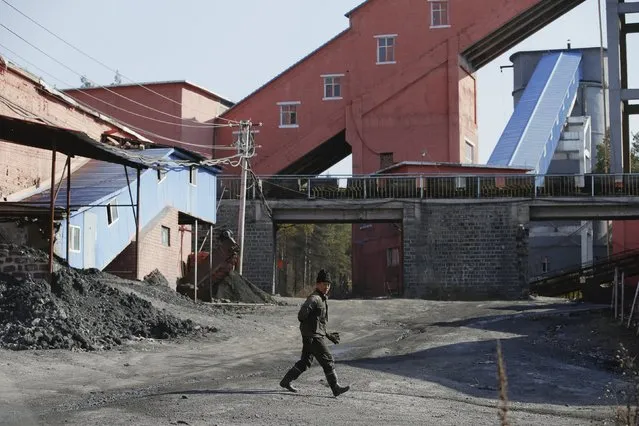 A miner walks at a coal mine from the state-owned Longmay Group on the outskirts of Jixi, in Heilongjiang province, China, October 24, 2015. (Photo by Jason Lee/Reuters)