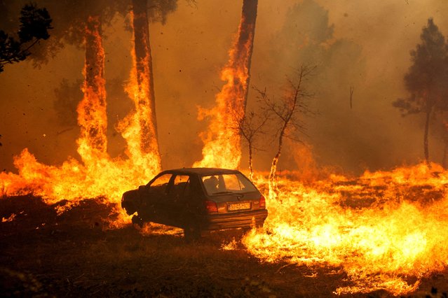 A car burns during the wildfire, in Meda, Portugal, on August 15, 2025. (Photo by Pedro Nunes/Reuters)