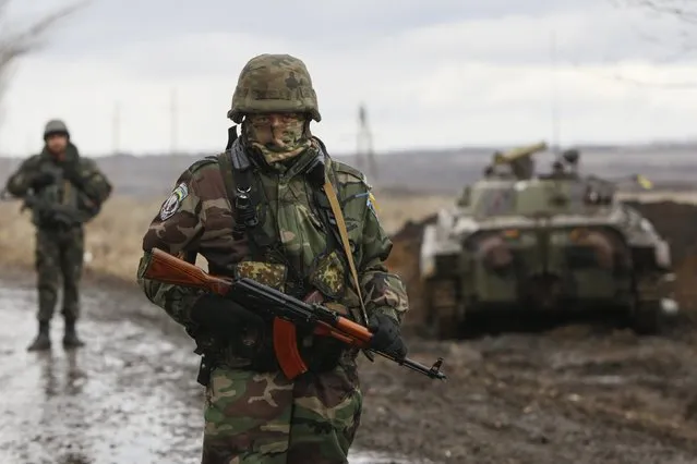 An Ukrainian serviceman guards at a checkpoint near the eastern Ukrainian town of Debaltseve in Donetsk region, December 24, 2014. (Photo by Valentyn Ogirenko/Reuters)