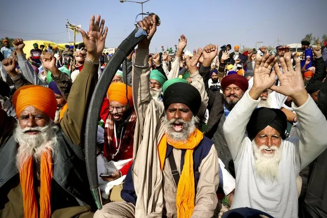 Protesting farmer leaders shout slogans as they sit on a day long hunger strike at the Delhi- Haryana border, outskirts of New Delhi, Monday, December14, 2020. Tens of thousands of protesting Indian farmers have called for a national strike on Monday, the second in a week, to press for the quashing of three new laws on agricultural reform that they say will drive down crop prices and devastate their earnings. (Photo by Manish Swarup/AP Photo)