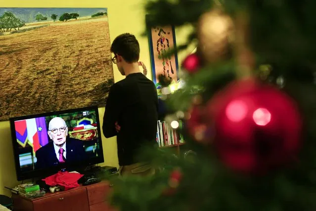A man looks at the television as Italian President Giorgio Napolitano delivers his speech to Italians in Rome December 31, 2014. Napolitano said on Wednesday he planned to step down soon, leaving Prime Minister Matteo Renzi facing his most difficult political challenge since he took power about 10 months ago. (Photo by Tony Gentile/Reuters)