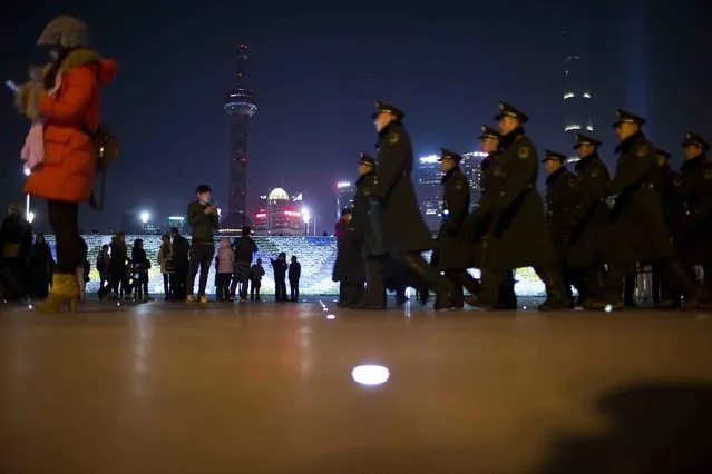 Paramilitary police officers walk on the location where people were killed in a stampede incident during a New Year's celebration on the Bund in Shanghai January 1, 2015. (Photo by Aly Song/Reuters)