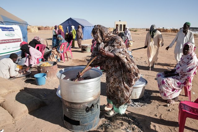 Sudanese women displaced from El-Fasher cook meals at a community kitchen inside the newly established El-Afadh camp in Al Dabbah, in Sudan's Northern State, Sunday, November 16, 2025. (Photo by Marwan Ali/AP Photo)