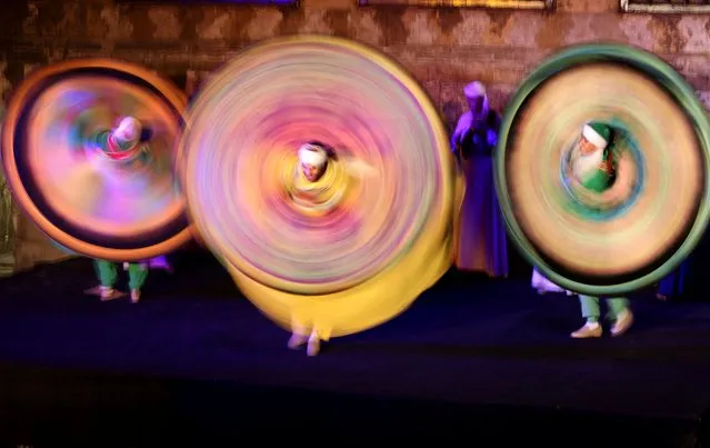 Traditional Egyptian dancers perform the Tanoura, an Egyptian version of Sufi dance, during the holy fasting month of Ramadan, at Al Ghouri Palace in the old Islamic area of Cairo, Egypt on April 12, 2023. (Photo by Mohamed Abd El Ghany/Reuters)