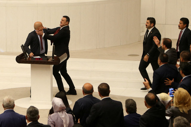 Turkey's AK Party lawmaker Alpay Ozalan scuffles with Workers' Party of Turkey (TIP) lawmaker Ahmet Sik, who was speaking during an extraordinary meeting of the Turkish parliament to discuss jailed opposition lawmaker Can Atalay's return to the assembly, in Ankara, Turkey on August 16, 2024. (Photo by Cagla Gurdogan/Reuters)