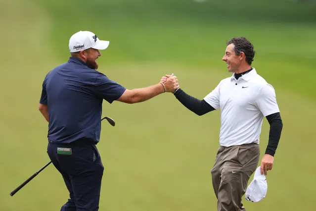 Shane Lowry of Ireland shakes hands with Rory McIlroy of Northern Ireland on the 18th green during the third round of the 2023 PGA Championship at Oak Hill Country Club on May 20, 2023 in Rochester, New York. (Photo by Andrew Redington/Getty Images)