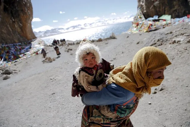 A Tibetan woman carries a child as they visit Namtso lake in the Tibet Autonomous Region, China November 18, 2015. (Photo by Damir Sagolj/Reuters)