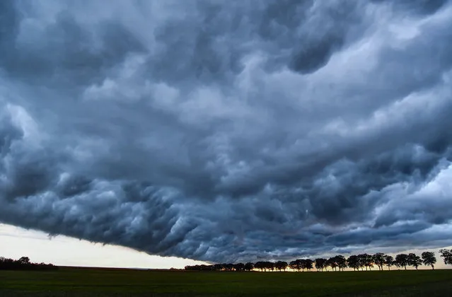 Dark storm clouds gather September 4, 2016 on a field in the Oder-Spree district near Sieversdorf, Brandenburg, Germany. (Photo by Patrick Pleul/DPA)