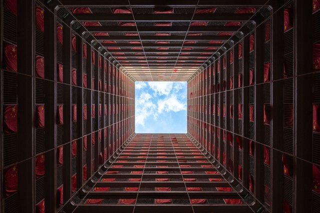 Flags of China are hung in a residential building to mark the 75th National Day of the People's Republic of China in Hong Kong, Tuesday, October 1, 2024. (Photo by Chan Long Hei/AP Photo)
