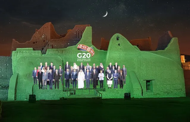 In this handout image provided by DGDA, Diriyah Gate Development Authority of Saudi, a family photo featuring members of the G20 is projected onto the walls of Salwa Palace, At Turaif on Saturday, November 20, 2020 in Diriyah, on the outskirts of Riyadh, Saudi Arabia. (Photo by Meshari-Alharbi/DGDA via AP Photo)