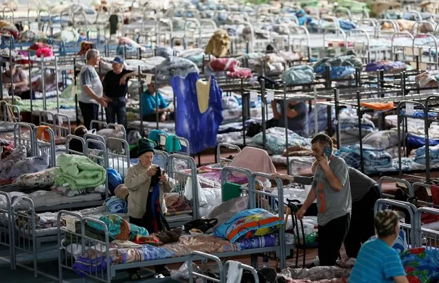 Residents of the Shebekinsky district of Russia's Belgorod region, who were evacuated following recent attacks on settlements near the Russia-Ukraine border in the course of a military conflict, stay at a temporary accommodation centre located in a sports facility in the city of Belgorod, Russia on June 7, 2023. (Photo by Maxim Shemetov/Reuters)