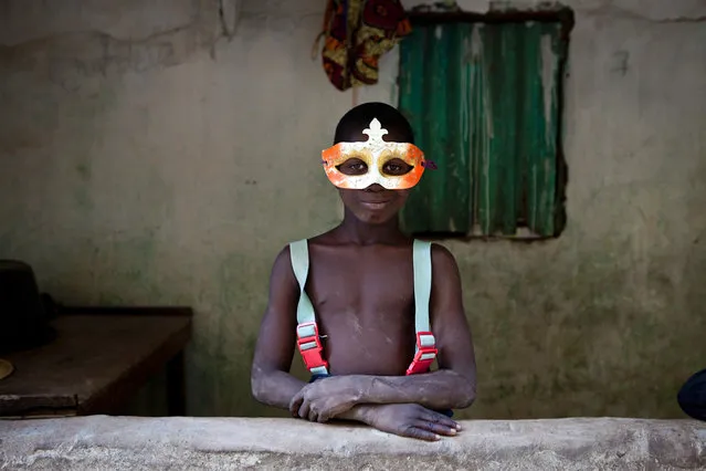 “The face of cultural fusion – Gambian village boy in a Mardi Gras mask”. On the final night of a 2 month, 1130km expedition down the River Gambia in West Africa, we pulled into the riverside village of Mandinari in The Republic of The Gambia to find a place to sleep. We entered a family compound and a young boy appeared wearing a Mardi Gras mask. At first I assumed it must be for special occasion or ceremony; no, he said just enjoyed wearing it. No, he did not know what Mardis Gras was, just that he found it at the village market. His portrait was the last one I made on the expedition and for me became symbolic of global cultural influences happening in Africa. (Photo and caption by Jason Florio/National Geographic Traveler Photo Contest)