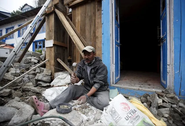 Six-time Everest summiteer Dorjee Sherpa works to rebuild his lodge that was damaged after the earthquake earlier this year in Solukhumbu district, also known as the Everest region, in this picture taken November 28, 2015. (Photo by Navesh Chitrakar/Reuters)