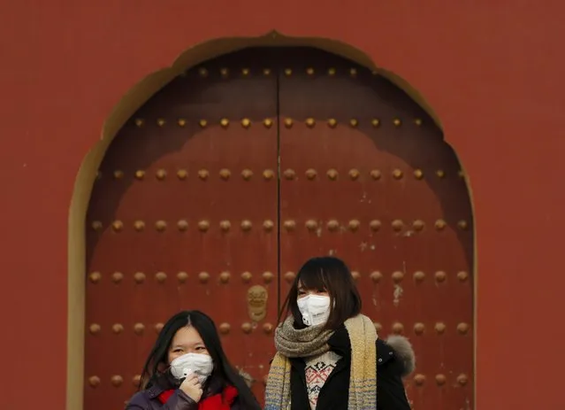 Women wearing protective masks visit the Temple of Heaven park as China's capital Beijing braces for four days of choking smog starting Saturday, in Beijing, China, December 19, 2015. (Photo by Kim Kyung-Hoon/Reuters)