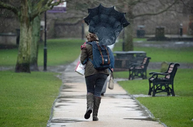 A gust of wind catches the umbrella of a person as they walk through the grounds of Winchester Cathedral in Winchester, Hampshire on January 20, 2021, as Storm Christoph is set to bring widespread flooding, gales and snow to parts of the UK. Heavy rain is expected to hit the UK, with the Met Office warning homes and businesses are likely to be flooded, causing damage to some buildings.(Photo by Andrew Matthews/PA Images via Getty Images)