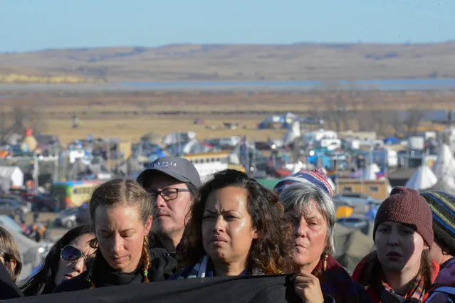 People attend a news conference at the Oceti Sakowin camp during a protest against plans to pass the Dakota Access pipeline near the Standing Rock Indian Reservation, near Cannon Ball, North Dakota, U.S. November 26, 2016. (Photo by Stephanie Keith/Reuters)