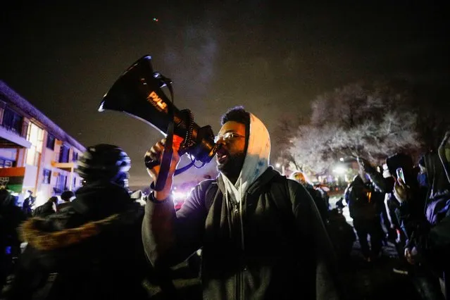 A person uses a megaphone as demonstrators confront law enforcement officers during a rally days after Daunte Wright, 20, was shot and killed by former Brooklyn Center Police Officer Kim Potter, in Brooklyn Center, Minnesota, April 13, 2021. (Photo by Nick Pfosi/Reuters)