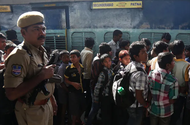 Indian rescued child laborers stand in a queue to board a train to be reunited with their parents in Bihar, one of India's poorest states, at a railway station in Hyderabad, India, Thursday, February 5, 2015. (Photo by Mahesh Kumar A./AP Photo)