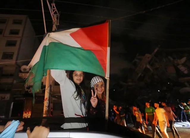 Palestinians take the streets after “mutual and simultaneous” cease-fire deal between Israel and Hamas reached with Egypt mediation took effect at 2 a.m. Friday (2300GMT Thursday), ending the 11-day conflict, in Gaza City, Gaza on May 21, 2021. (Photo by Ashraf Amra/Anadolu Agency via Getty Images)