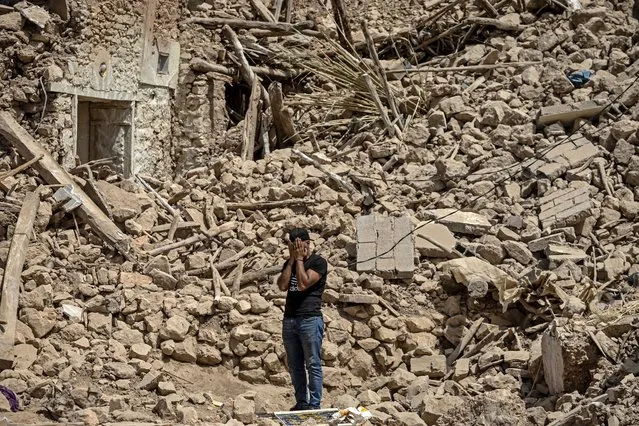 A volunteer reacts amid the rubble of destroyed houses in the village of Douzrou on September 12, 2023 following a 6.8-magnitude quake. Hopes dimmed in Morocco's search for survivors, four days after a powerful earthquake killed more than 2,800 people, most of them in remote villages of the High Atlas Mountains. (Photo by Fadel Senna/AFP Photo)