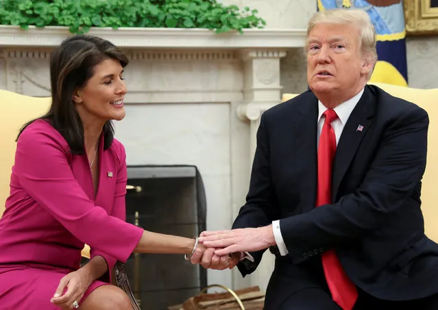 U.S. President Donald Trump greets U.N. Ambassador Nikki Haley in the Oval Office of the White House as the president accepted the Haley's resignation in Washington, U.S., October 9, 2018. (Photo by Jonathan Ernst/Reuters)