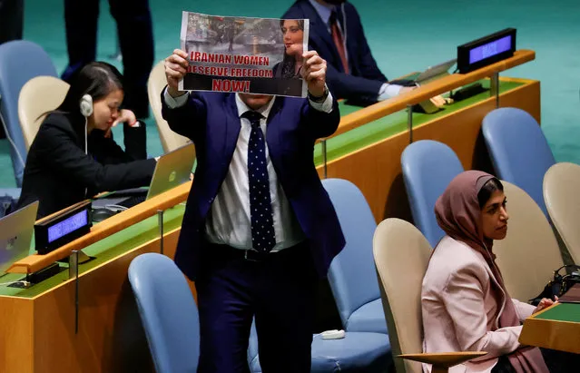Israel's Ambassador to the United Nations Gilad Erdan leaps up with a sign in support of womens' rights in Iran, on the floor of the United Nations General Assembly before being led out of the hall by U.N. security officials as Iran's President Ebrahim Raisi began addressing the 78th Session of the U.N. General Assembly in New York City, U.S., September 19, 2023. (Photo by Eduardo Munoz/Reuters)