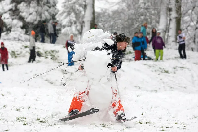 Young Finalist – David Hedges. Simon Bates, 23, skis into a snowman in Brandon hill park in the centre of Bristol on January 18, 2013. Much of the South West has been convered in a blanket of snow, causing travel chaos. (Photo by David Hedges/South West News Service)