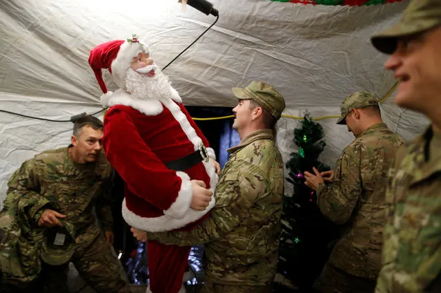 U.S. soldiers enjoy a Christmas dinner at an army base in Karamless town, east of Mosul, December 25, 2016. (Photo by Ammar Awad/Reuters)