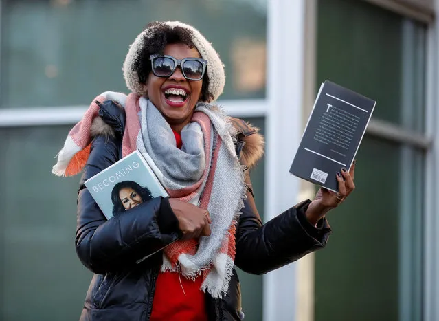 Jenny LeFlore smiles after getting signed copies of former first lady Michelle Obama's memoir Becoming outside the Seminary Co-op Bookstore in Chicago on November 13, 2018. (Photo by Kamil Krzaczynski/Reuters)