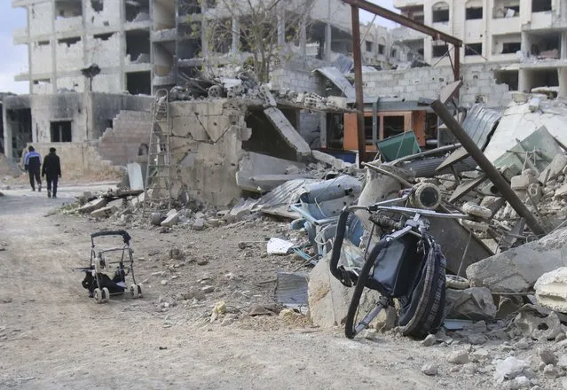 Baby strollers are seen near the debris of damaged buildings in Jobar, a suburb of Damascus, January 5, 2015. (Photo by Diaa Al-Din/Reuters)