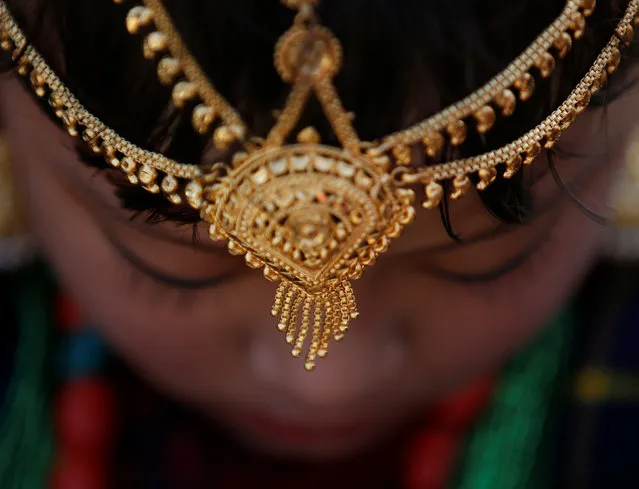 An adorned Gurung girl wearing traditional costume and ornaments is seen during Tamu Lhosar or Losar (New Year) parade in Kathmandu, Nepal December 30, 2016. (Photo by Navesh Chitrakar/Reuters)