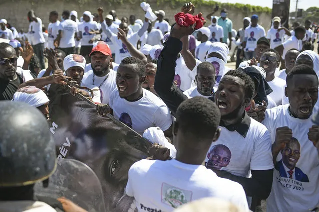 Supporters of slain Haitian President Jovenel Moise are blocked from attending Moise's funeral outside the former leader's family home as they call for justice in Cap-Haitien, Haiti, Friday, July 23, 2021. (Photo by Matias Delacroix/AP Photo)