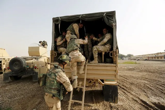 Iraqi security forces climb into trucks travelling to Mosul to fight against militants of Islamic State at an Iraqi army base in Camp Taji in Baghdad, February 21, 2016. (Photo by Ahmed Saad/Reuters)