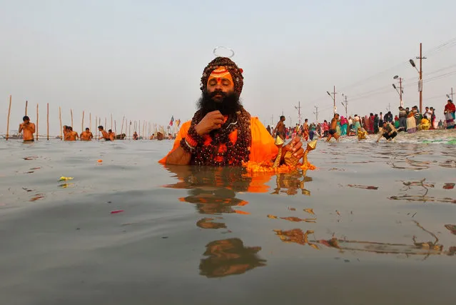 A Sadhu or a Hindu holy man prays as he takes a dip at Sangam, a confluence of three rivers, the Ganga, the Yamuna and the mythical Saraswati, on the occasion of “Makar Sankranti” festival in Allahabad, India, January 14, 2017. (Photo by Jitendra Prakash/Reuters)