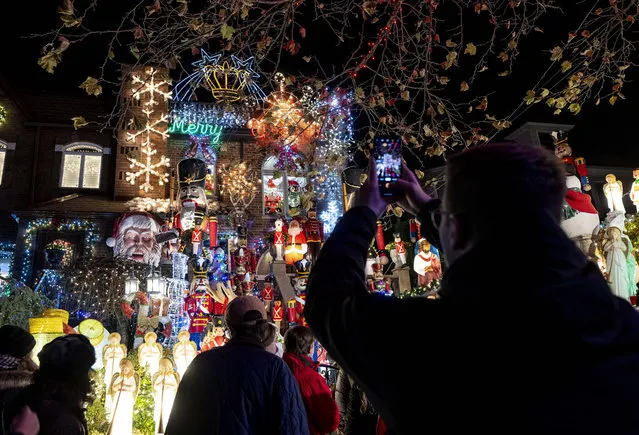 Christmas lights and ornaments are viewed outside of a home in Dyker Heights neighborhood of Brooklyn borough of New York, United States on December 6, 2022. Dyker Heights is one of the most culturally and ethnically diverse areas in the nation, hosts numerous neighborhoods where Christmas tree lights have become a significant attraction with hundreds of cars and pedestrians arriving daily to view the homes. The Dyker Heights neighborhood has become the most popular area for Christmas lights viewing. (Photo by Fatih Aktas/Anadolu Agency via Getty Images)