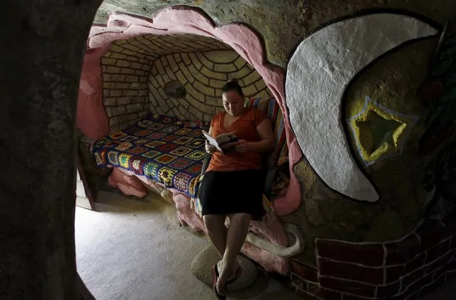 Lidieth Barrantes reads a book in one of the rooms of the house that her father built underground in San Isidro de Perez Zeledon, Costa Rica, March 14, 2016. (Photo by Juan Carlos Ulate/Reuters)
