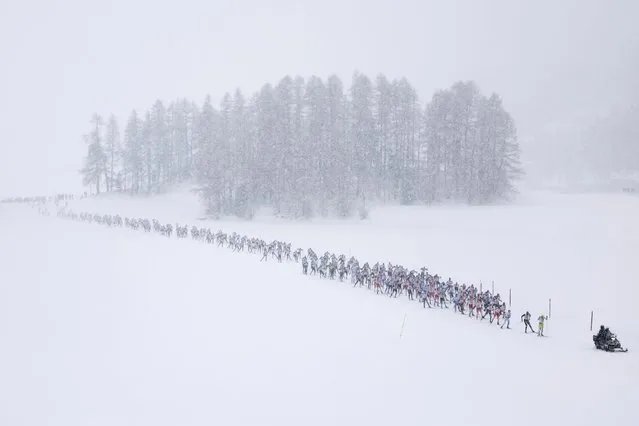 The pack of skiers is on its way from Silvaplana to S-Chanf as they participate in the 54th annual Engadin skiing marathon, on Sunday, March 10, 2024, in Silvaplana, Switzerland. The start was in Silvaplana instead of Maloja due to snow and temperatures. (Photo by Peter Klaunzer/Keystone)
