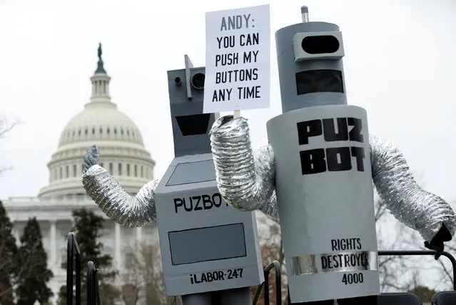 Federal contract workers protest as they dressed as robots and rally to celebrate Andrew Puzder's decision to withdraw from consideration to be secretary of labor on Capitol Hill in Washington, U.S. February 16, 2017. (Photo by Yuri Gripas/Reuters)