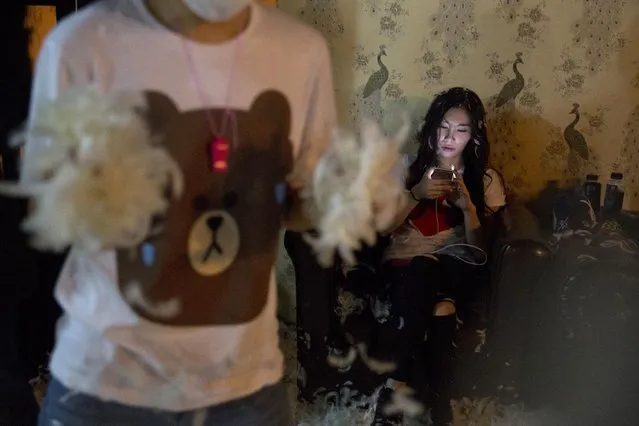 A participant takes a break from a pillow fight event in Beijing, China, Saturday, April 2, 2016. (Photo by Ng Han Guan/AP Photo)