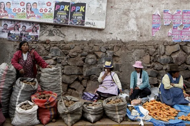 Women sell potatos next to electoral posters of Peru's presidential candidates Veronika Mendoza of the Frente Amplio party and Pedro Pablo Kuczynski of the Peruanos Por El Cambio party in the district of San Jeronimo in Cuzco, Peru April 9, 2016, ahead of Sunday's presidential election. (Photo by Janine Costa/Reuters)