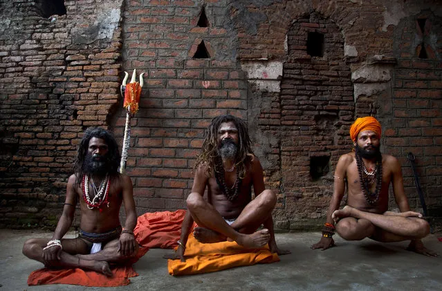 Indian Sadhus, or Hindu holy men, perform yoga on International Yoga Day at Kamakhya temple in Gauhati, India, Friday, June 21, 2019. (Photo by Anupam Nath/AP Photo)