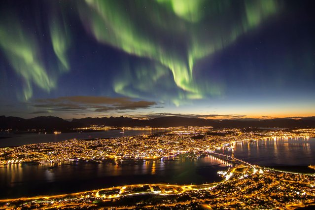 Northern lights (Aurora Borealis) illuminate the sky in Tromso, located in the Arctic Circle, Norway, on March 3, 2024. (Photo by Alamy/PA Wire Press Association)