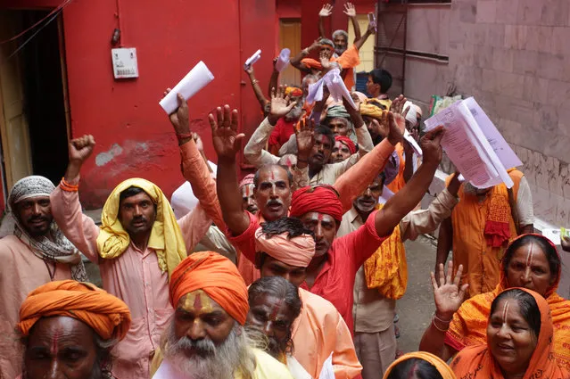 Indian Hindu holy men and women queue for registration for the Amarnath shrine pilgrimage at the registration center in Jammu, the winter capital of Kashmir, India, 09 July 2019. The annual pilgrimage to a cave shrine, housing a naturally formed icy stalagmite, attracts hundreds of thousands of Hindu pilgrims annually for two months. (Photo by Jaipal Singh/EPA/EFE)