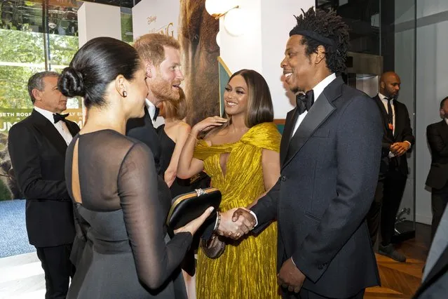 Britain's Prince Harry, Duke of Sussex, and Meghan, Duchess of Sussex, meet cast and crew, including U.S. singer-songwriter Beyonce and her husband, U.S. rapper Jay-Z, as they attend the European premiere of the film The Lion King in London, Britain on July 14, 2019. (Photo by Niklas Halle'n/Pool via Reuters)