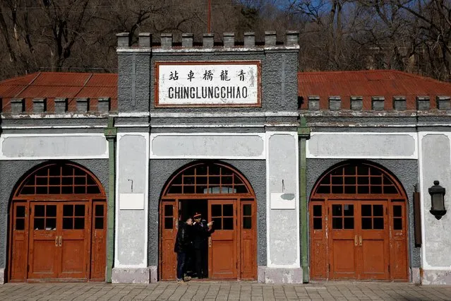 A museum staff member talks to a man outside the historic Qinglongqiao railway station, previously called Chinglungchiao, in Badaling, northwest of Beijing, China, March 1, 2017. (Photo by Thomas Peter/Reuters)